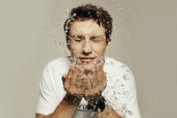 man washing his face while wearing realme Watch S