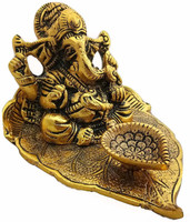 Decor and Art Metal Golden Oxidized Ganesh Ji Sitting On Leaf With Diya Decorative Showpiece  -  6 cm(Metal, Gold)