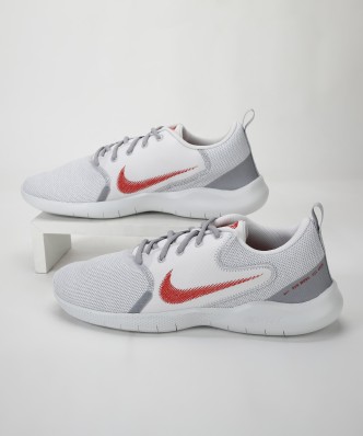 gray nike shoes with red swoosh