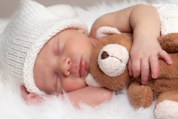 baby sleeping with teddy