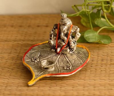 68% OFF on eCraftIndia Lord Ganesha with Diya on Leaf Decorative Showpiece - 10.16 cm(Aluminium, Silver)