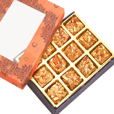

Ghasitaram Gifts Ghasitaram's Orange Printed 12 pcs Roasted Almond Bites Box with Diamond Rakhi(500 g, Box)