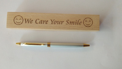 SMART WORLD Beautifully wooden engraved WE CARE YOUR SMILE pen box with Matt silver finish with golden clip Ball Pen Ball Pen(Ink Color - Blue)