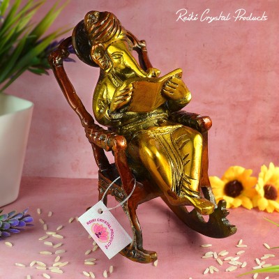 REIKI CRYSTAL PRODUCTS Brass Lord Ganesha Statue Sitting on A Chair and Reading Shri Ganesh Statue Ganesha Idol Laddu Ganesh Ji Siddhi Vinayak Home Decor Figurine Ganesha Diwali Gifts Decorative Showpiece  -  16 cm(Brass, Gold, Red)