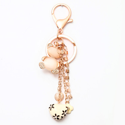 

Lotus E GOLDEN & CRYSTALS METALLIC HANGING WHITE HEART AND TEDDY Key Chain