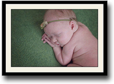 

Baby sleeping on green carpet Fine Art Print(10 inch X 14 inch, Framed)