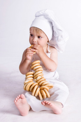 

Child's Love - Chef Girl Eating Doughnut Paper Print(18 inch X 12 inch, Stretched)