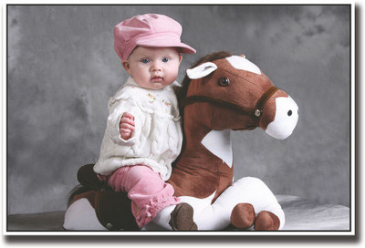 

Cute Baby on toy horse Fine Art Print(12 inch X 18 inch, Rolled)