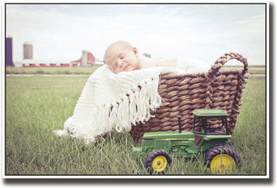 

Baby sleeping with a toy tractor Fine Art Print(12 inch X 18 inch, Rolled)