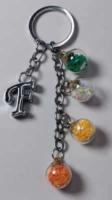 MOREL F ALPHABET KEYCHAIN WITH COLORIZED SHINING STAR DRIFTING GLASS 4 BOTTLE ROUND. Key Chain