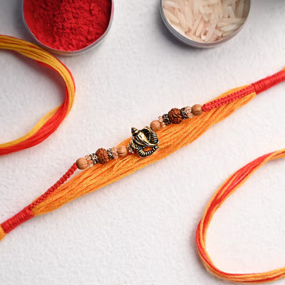 LYBASHINE Designer Auspicious Ganesha Rakhi with Rudraksha Beads & Orange-Red Thread Assorted Rakhi, Chawal Roli Pack  Set(1 Pc Rakhi, 1 Roli, 1 Chawal)