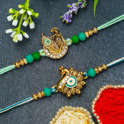 eCraftIndia Religious D1829 Assorted Rakhi  Set(Set of 2 Peacock Krishna Rakhis, Roli Chawal Pack)