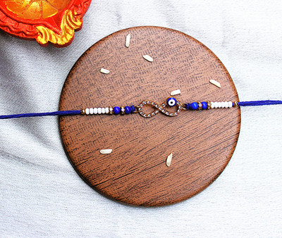 TOMUNCLE Designer Blue Evil Eye Rakhi with Infinity Charm for Raksha - premium rakhi Assorted Chawal Roli Pack  Set(Pearl, Yarn)
