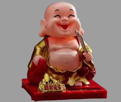 tskutty CHILD Solar Laughing Buddha with Holding Ingot and Waving Fan MovinG HEAD Decorative Showpiece  -  9 cm(Plastic, Multicolor)
