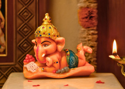 Magic Creation Lying Bal Ganesha with Laddus & Book – Polyresin Ganpati Statue for Home Office Decorative Showpiece  -  12.8 cm(Polyresin, Orange)