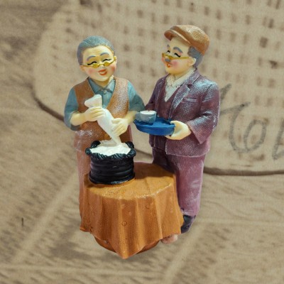 Sawcart Grand Parents Dada Dadi Old Romantic Loving Couple Baking Cake and Having Tea Decorative Showpiece  -  13 cm(Polyresin, Multicolor)