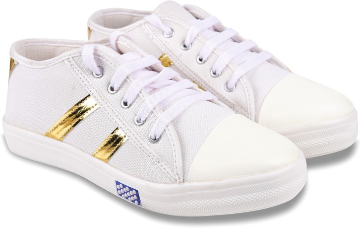 white sneakers with gold stripes