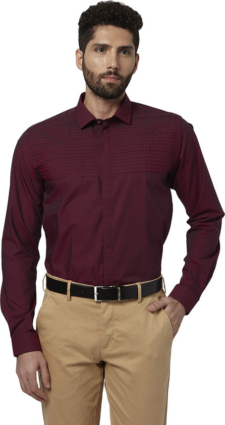 maroon shirt and brown pants