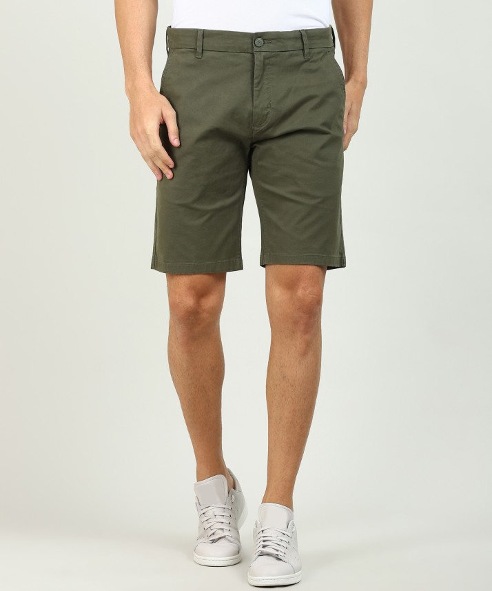 green levi shorts
