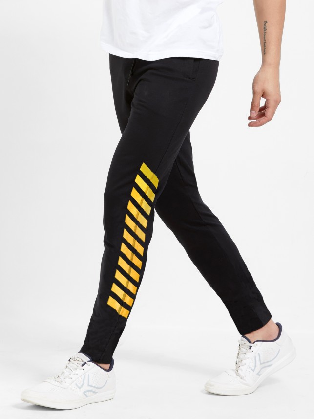 black track pants with yellow stripe