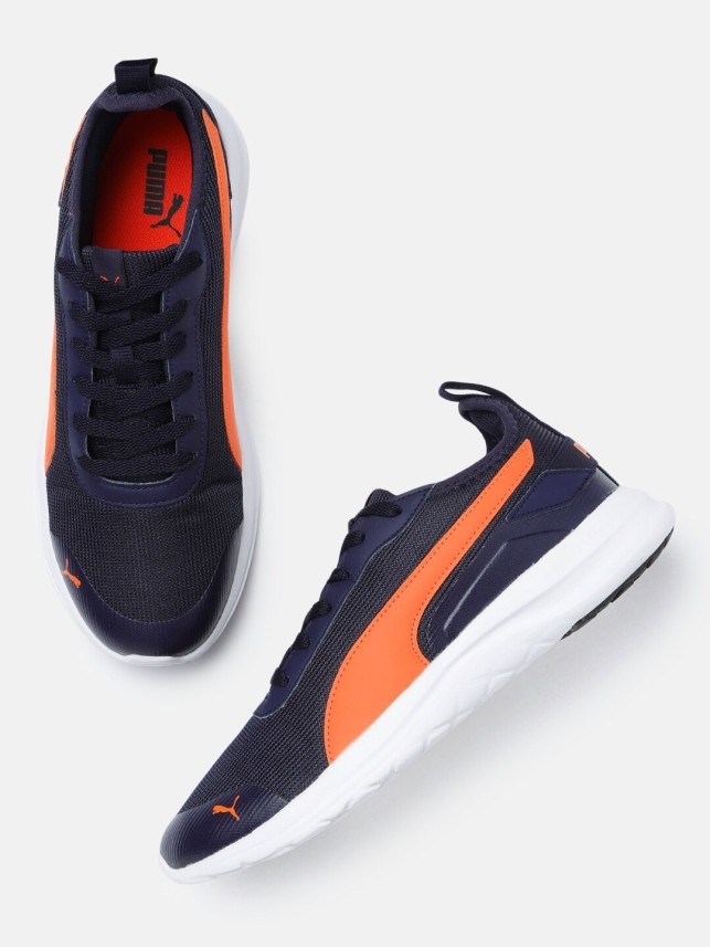 navy blue and orange pumas