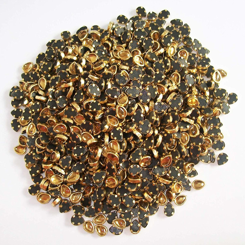 hglass Tilak Shape Golden Stones are Used for The Embellishment of Sarees, Lehenga and Other Couture Wears. (6mm 1700pcs)