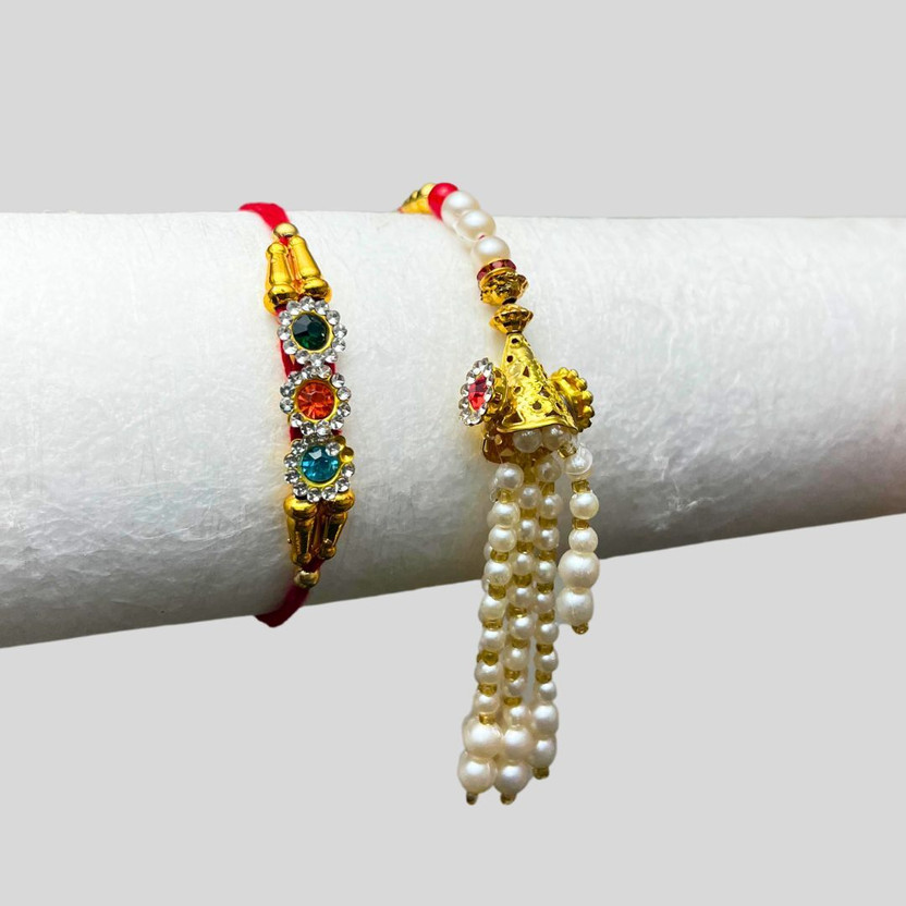 THE INDIA STYLE Bhaiya Bhabhi Veera Chamak & Pink Lumba Chuda Rakhi For Bhabhi ( Multicolor) 2 Mauli Thread, Kundan Rakhi, Chawal Roli Pack, Greeting Card  Set(Blue Mor pankha and Lumba Chuda Hanging Rakhi set of-2, 1 Packet Roli Chawal)