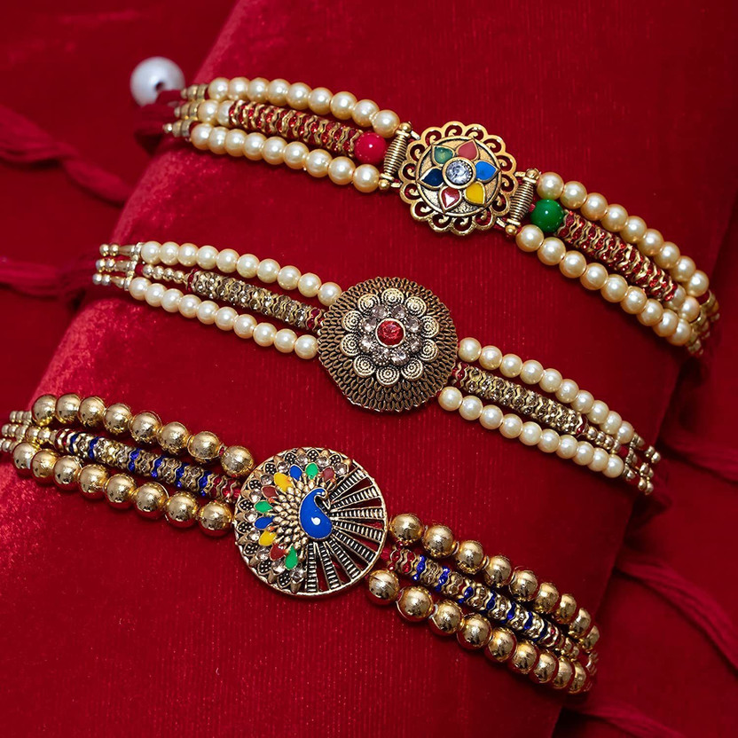 Designer SAINI-LOV158 Gold Finish Rakhi, Chawal Roli Pack Set by Bloom(3 Rakhi, 1 Roli Chawal Pack)