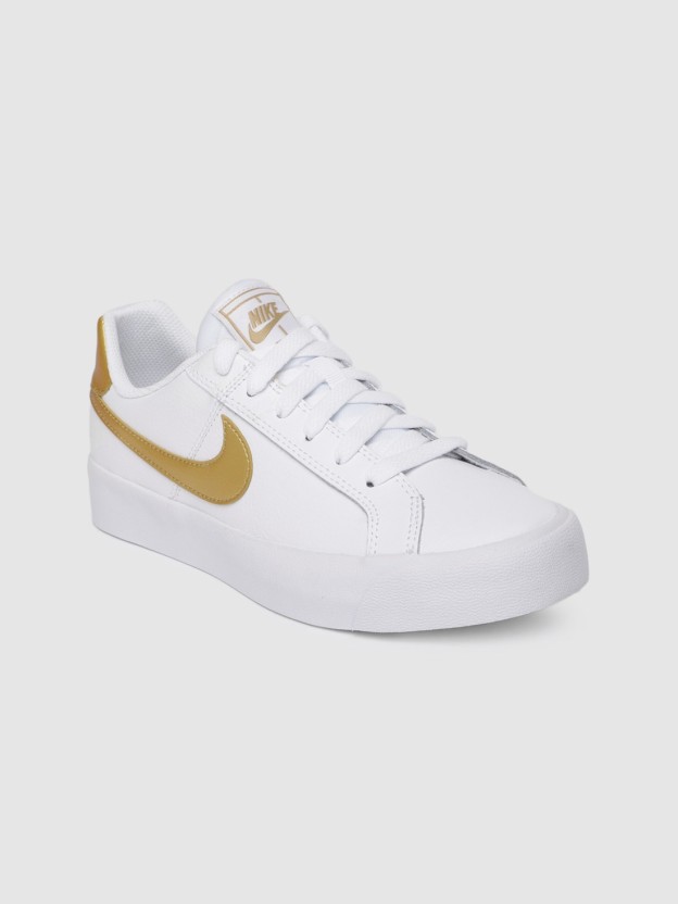 white and gold nike tennis shoes