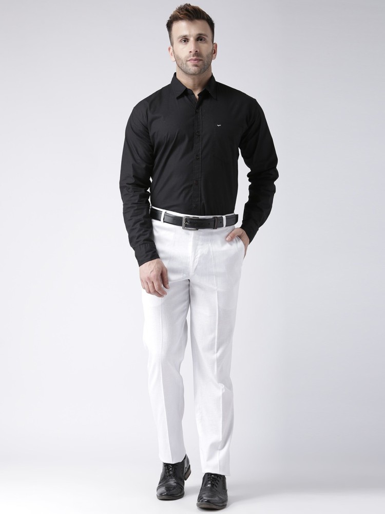 Free Photo  Handsome man in white shirt and black trousers  posing  attractive guy with fashion hairstyle confident man with short beard  adult stylish boy with brown hair