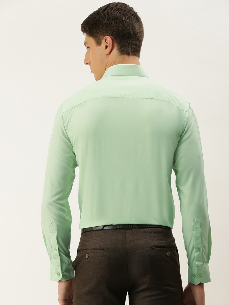 light green shirt and black pants