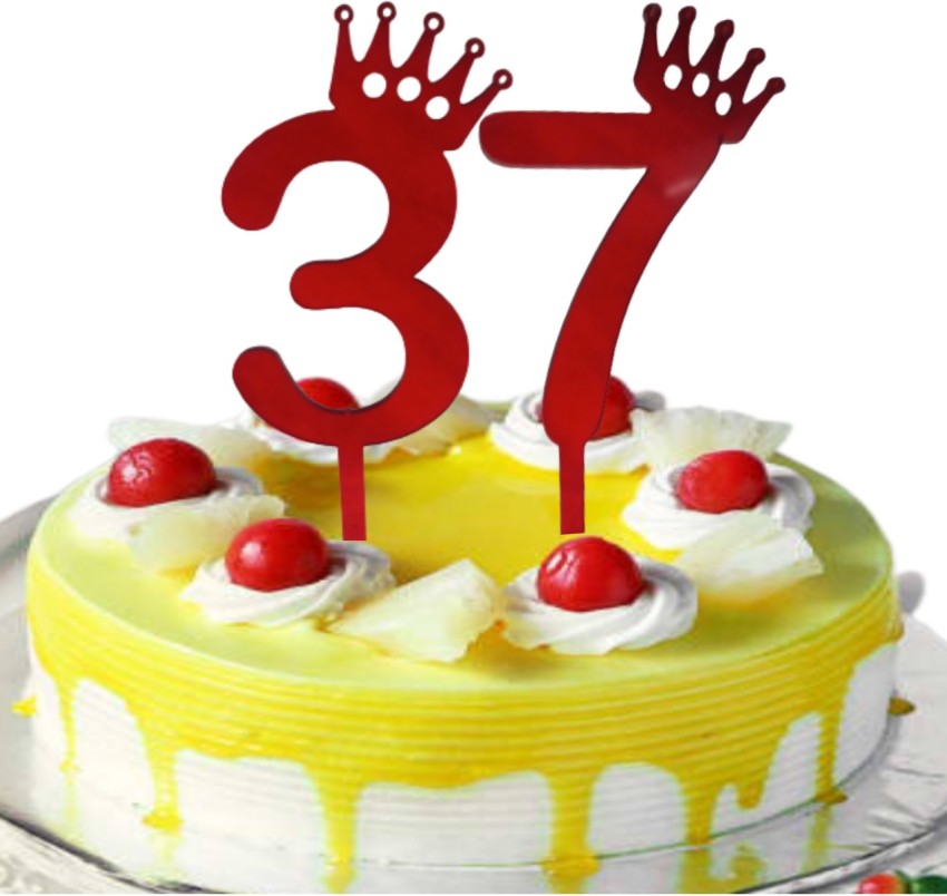 White birthday cake number 37 golden candles burning by lighter, blue  background with lights and gift yellow box tied up with red ribbon.  Close-up Stock Photo | Adobe Stock