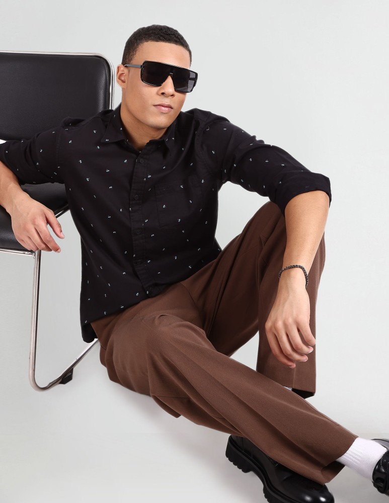 Premium Photo | Picture of beautiful caucasian man without hair with black  sunglasses in a shiny shirt, black leather pants and grey sneakers sings in  a small silver microphone